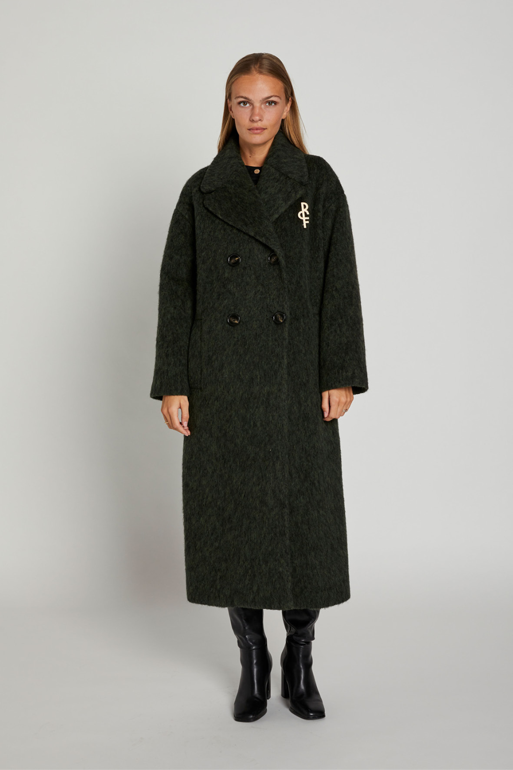 Jakke, frakke, coat, lang, grøn, army, mørk, uld, wool, uldjakke, broche, logo, varm, oversize, stor, dobbeltradet, ulden, lodden, langhåret, fin, smuk, elegant, klassisk, feminin, pæn, rå, cool, sej, unik, musthave, hverdag, fest,